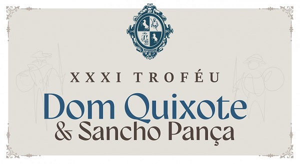 Arte com funbdo cinza e, na parte superior, um brasãoi com figuras de dois cavalo, um cavaleiro e uma armadura. Abaixo, escrito: XXXI Troféu Dom Quizote e Sancho Pança.